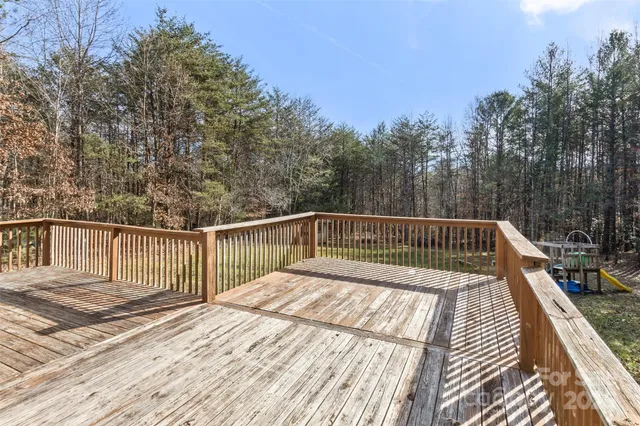 a view of balcony with wooden floor and fence