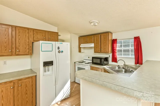 a kitchen with stainless steel appliances a refrigerator and a stove top oven