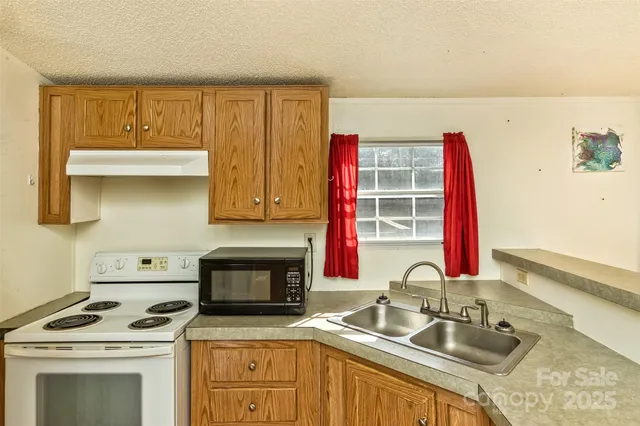 a kitchen with stainless steel appliances a stove sink and cabinets