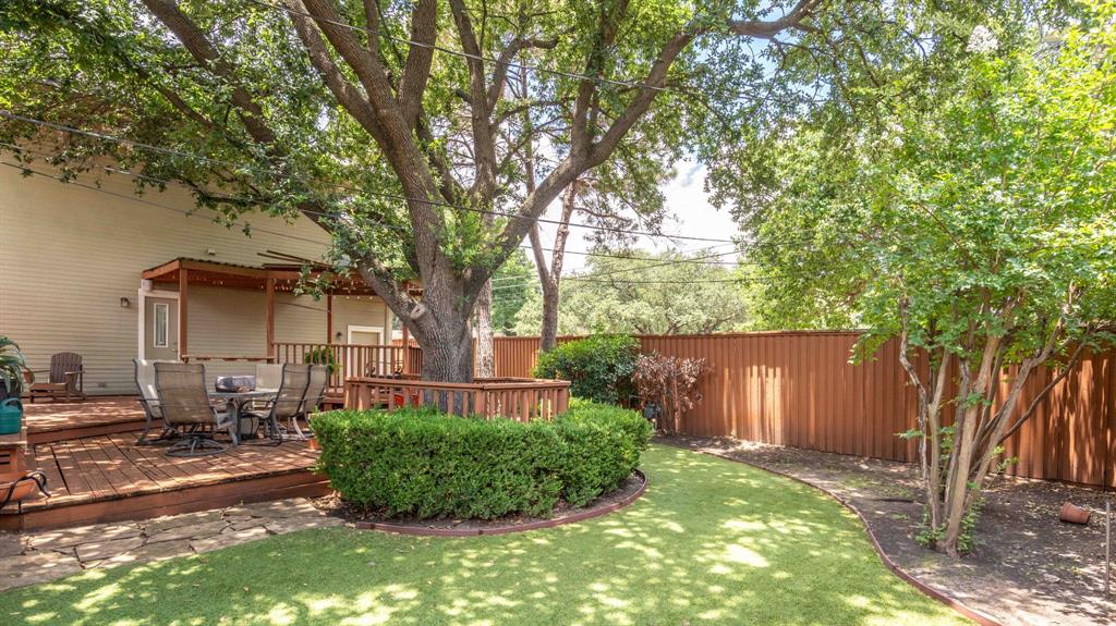 6405 Azalea Lane Dallas, TX 75230 - Photo 6 of 11 a front view of a house with garden