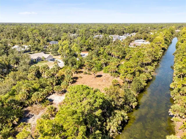 a view of a yard with wooden fence