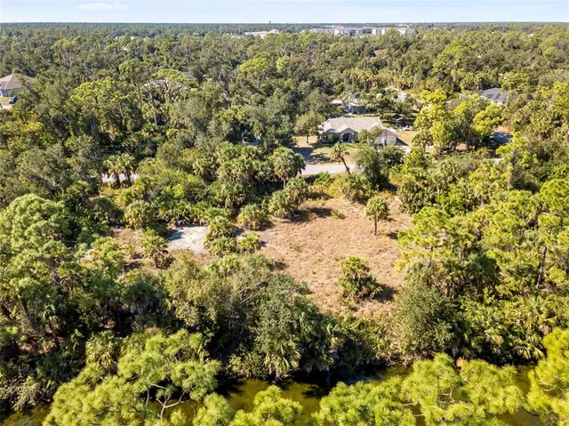 a view of a yard with wooden fence