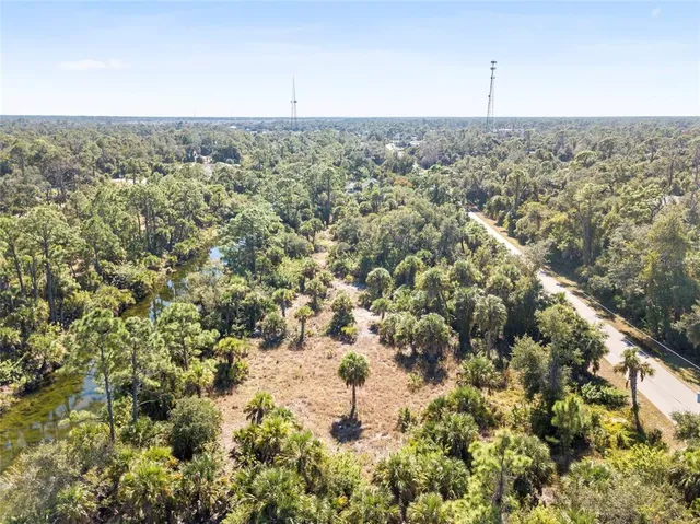 an aerial view of residential houses with city view
