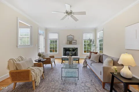 a living room with furniture fireplace and a window