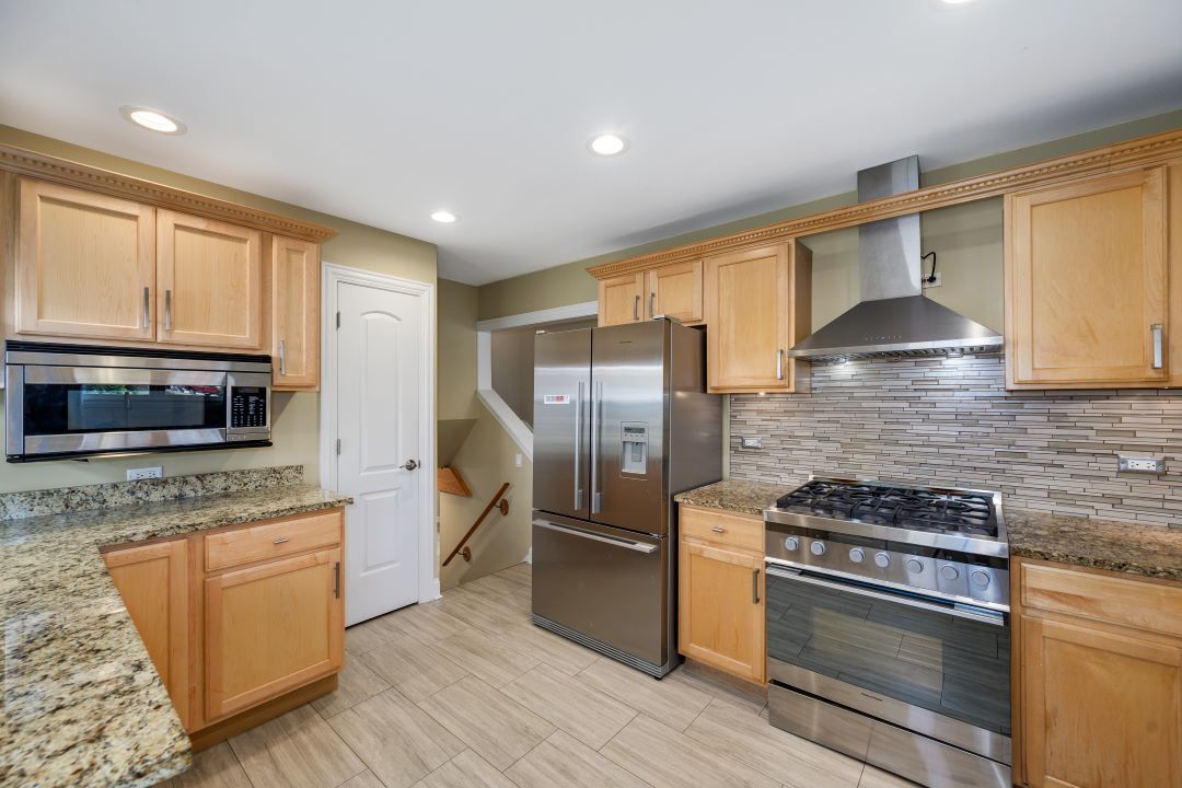 1700 Marvin Parkway Park Ridge, IL 60068 - Photo 12 of 26 a kitchen with stainless steel appliances granite countertop a stove a sink and a microwave