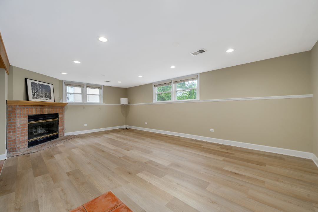 1700 Marvin Parkway Park Ridge, IL 60068 - Photo 18 of 26 an empty room with wooden floor fireplace and windows