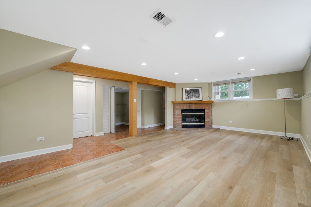 1700 Marvin Parkway Park Ridge, IL 60068 - Photo 19 of 26 a view of an empty room with wooden floor and a kitchen