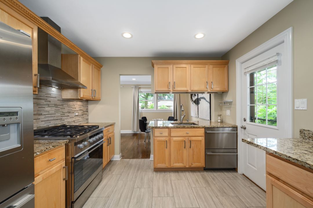 1700 Marvin Parkway Park Ridge, IL 60068 - Photo 10 of 26 a kitchen with stainless steel appliances a stove a sink dishwasher a refrigerator white cabinets and wooden floor