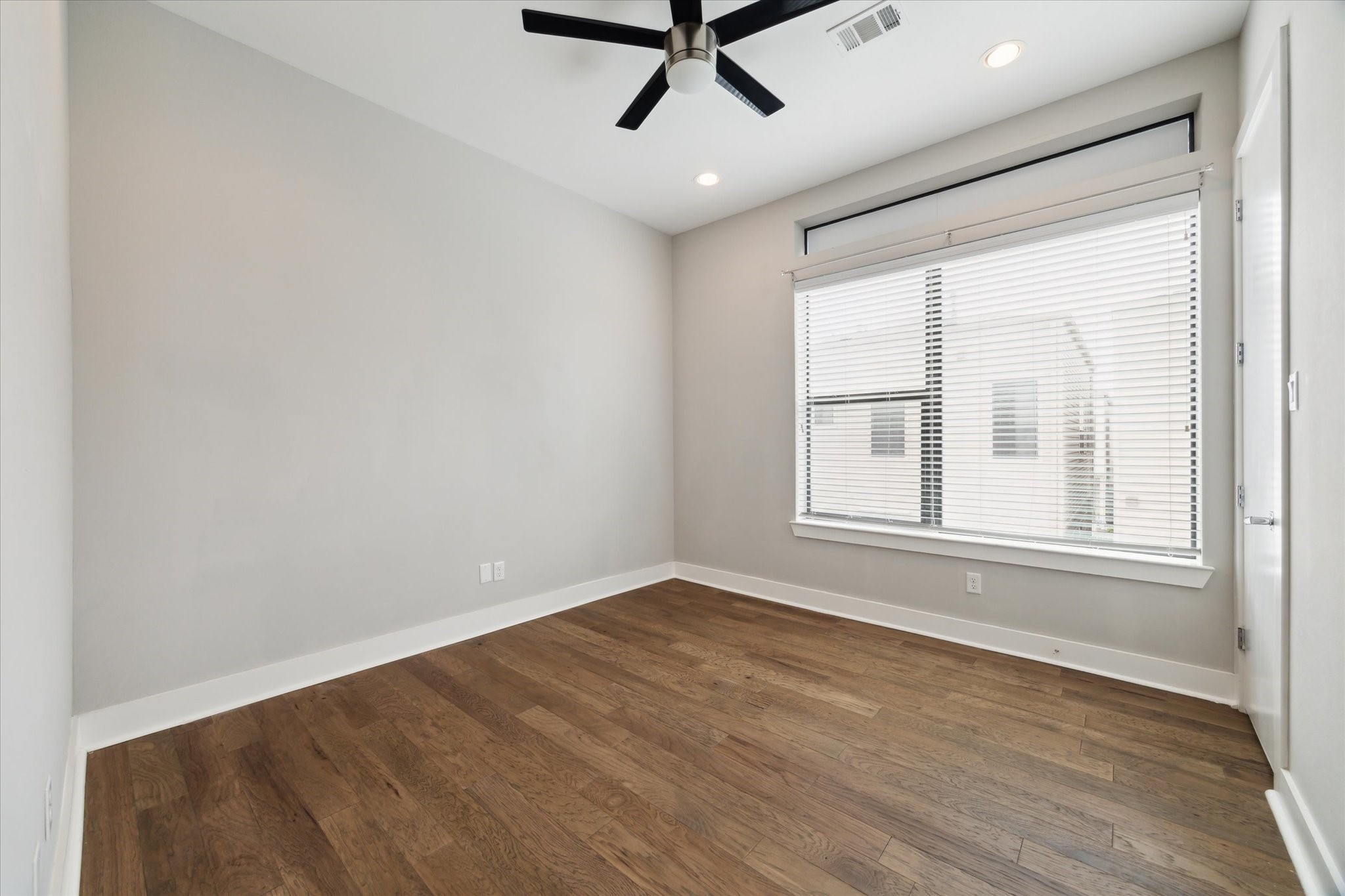614 Thornton Road, Unit G Houston, TX 77018 - Photo 15 of 18 a view of an empty room with a window and wooden floor