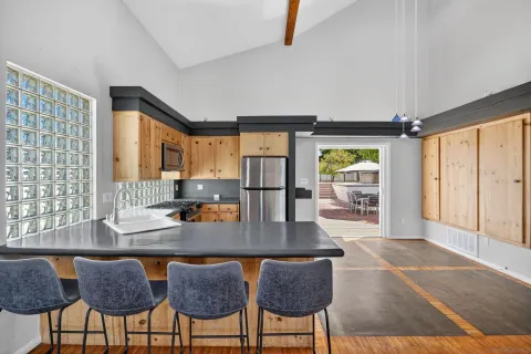 a kitchen with granite countertop a table chairs stove and granite counter top