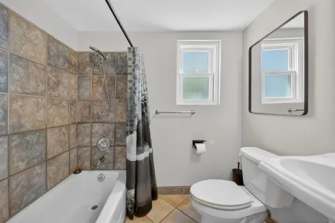 a bathroom with a sink mirror and toilet