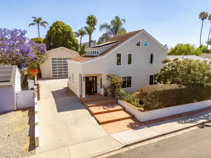 a front view of house with a yard and outdoor seating