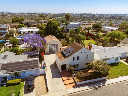 an aerial view of a house with a yard