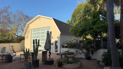 a view of a house with backyard and sitting area
