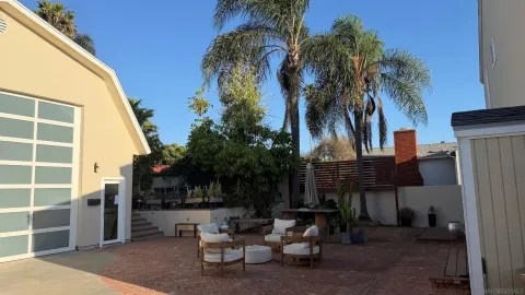 a view of a patio with a table and chairs and potted plants