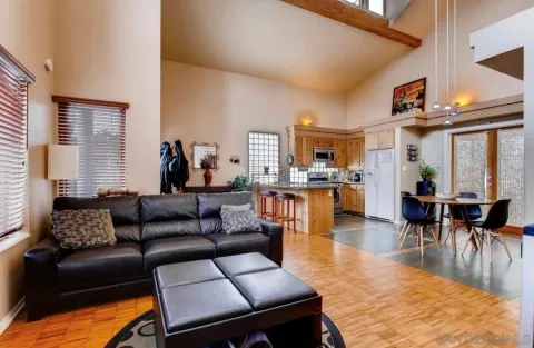 a living room with furniture a wooden floor and a window