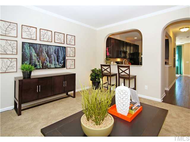 764 Wickham Ridge Road, Unit 108 Apex, NC 27539 - Photo 11 of 20 a living room with furniture a rug and white walls