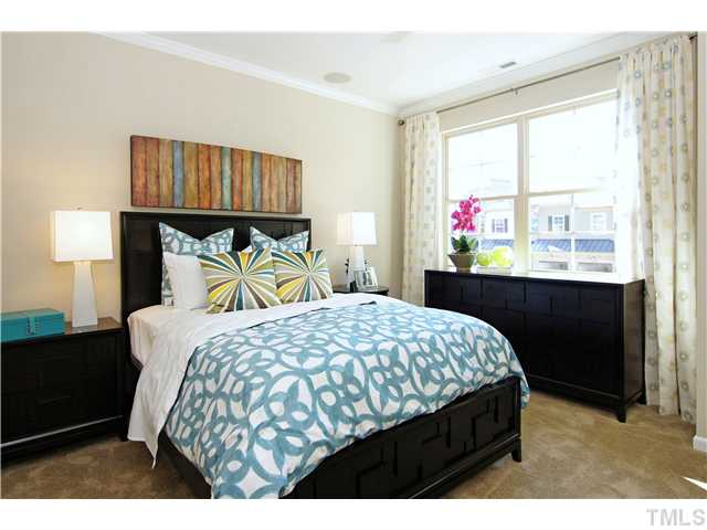 764 Wickham Ridge Road, Unit 108 Apex, NC 27539 - Photo 12 of 20 a bedroom with a bed a dresser and a window