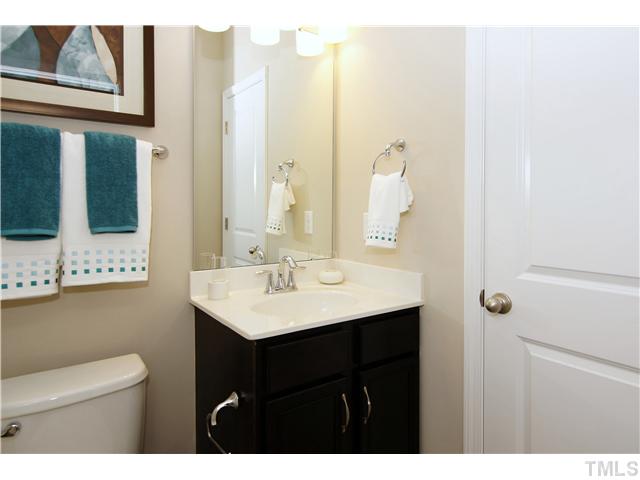 764 Wickham Ridge Road, Unit 108 Apex, NC 27539 - Photo 16 of 20 a bathroom with a sink a mirror and a toilet