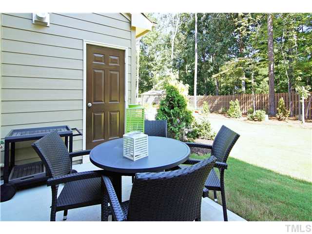 764 Wickham Ridge Road, Unit 108 Apex, NC 27539 - Photo 18 of 20 a outdoor dining space with furniture and outdoor view