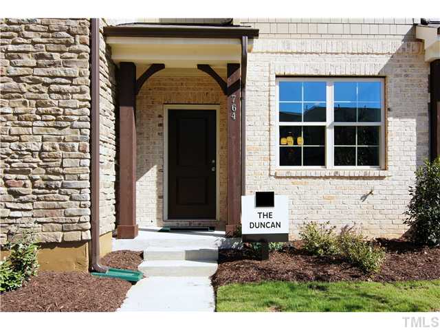 764 Wickham Ridge Road, Unit 108 Apex, NC 27539 - Photo 2 of 20 a front view of a house with a yard