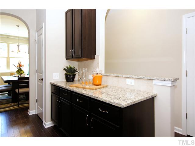 764 Wickham Ridge Road, Unit 108 Apex, NC 27539 - Photo 8 of 20 a bathroom with a granite countertop sink and a mirror