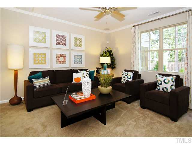 764 Wickham Ridge Road, Unit 108 Apex, NC 27539 - Photo 9 of 20 a living room with furniture potted plant and a window