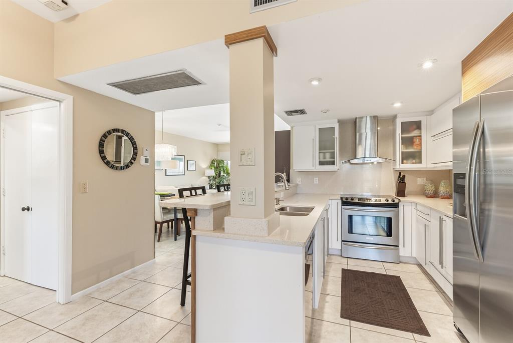 5000 Gasparilla Road, Unit 53A Boca Grande, FL 33921 - Photo 13 of 55 a kitchen with stainless steel appliances granite countertop a refrigerator and a stove top oven