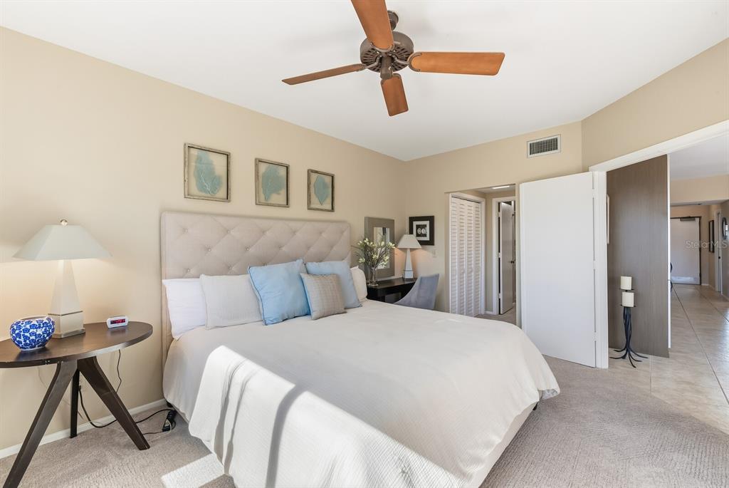 5000 Gasparilla Road, Unit 53A Boca Grande, FL 33921 - Photo 15 of 55 a bedroom with a bed and a chandelier