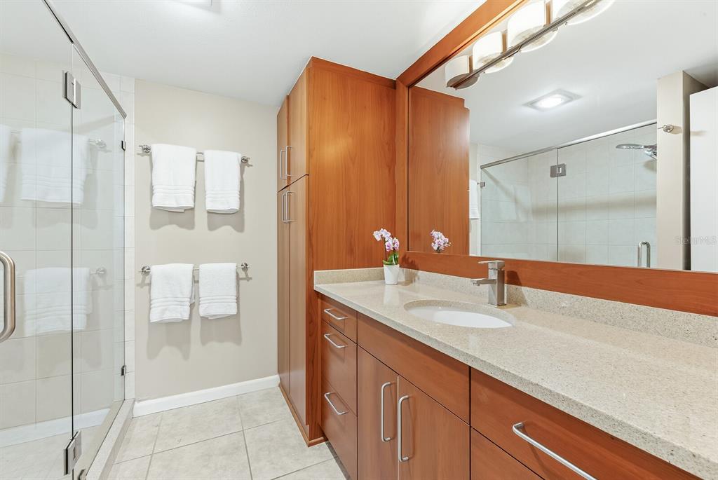 5000 Gasparilla Road, Unit 53A Boca Grande, FL 33921 - Photo 16 of 55 a bathroom with a shower sink and mirror