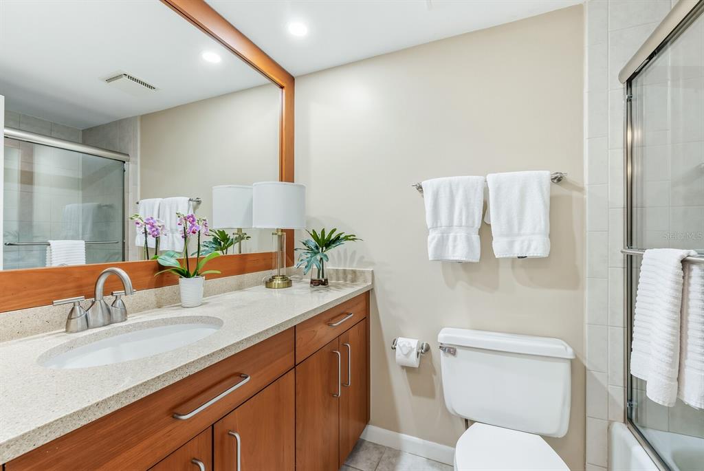 5000 Gasparilla Road, Unit 53A Boca Grande, FL 33921 - Photo 18 of 55 a bathroom with a granite countertop toilet sink and mirror