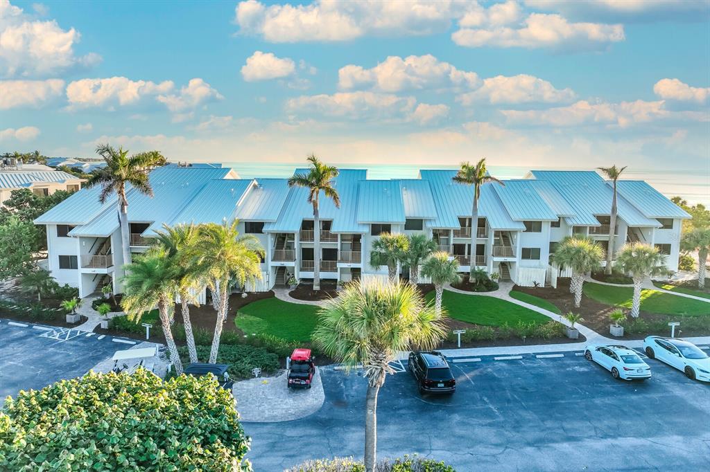 5000 Gasparilla Road, Unit 53A Boca Grande, FL 33921 - Photo 21 of 55 a view of a house with a garden and patio