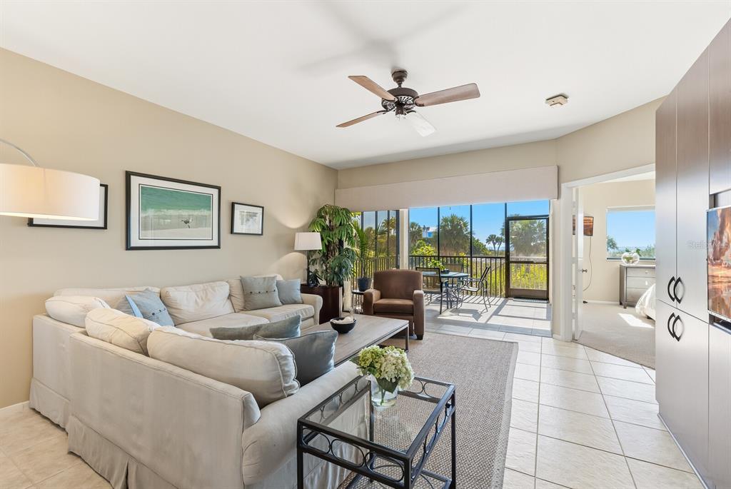 5000 Gasparilla Road, Unit 53A Boca Grande, FL 33921 - Photo 9 of 55 a living room with furniture and a large window