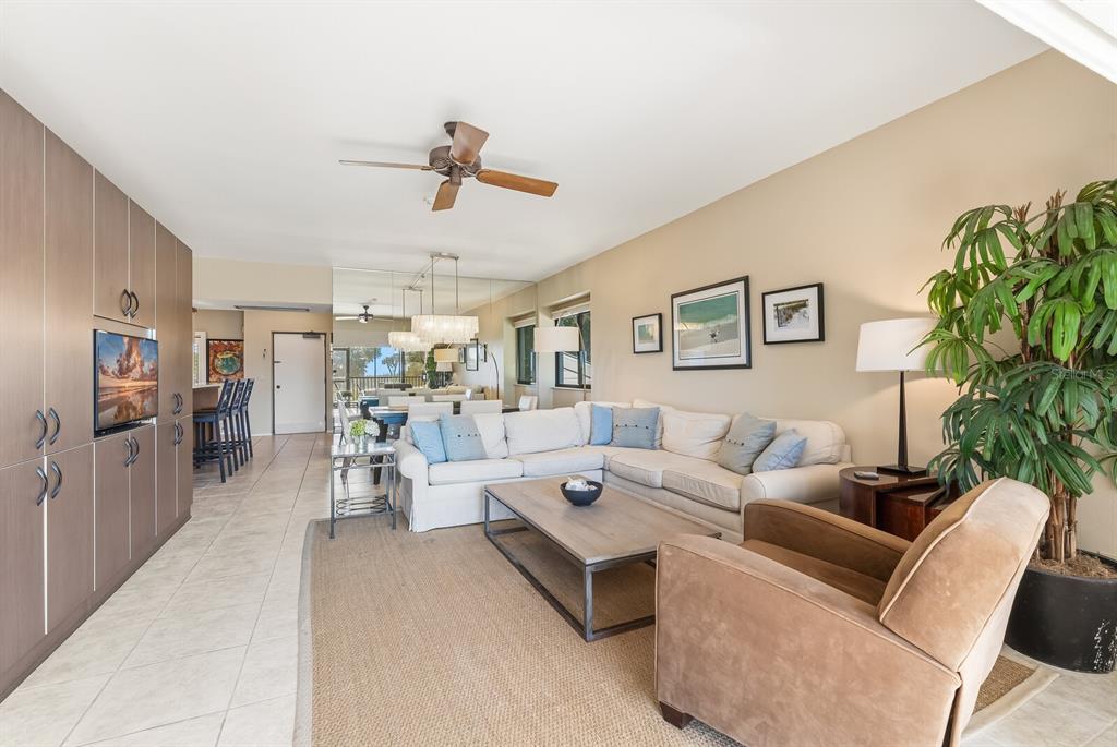 5000 Gasparilla Road, Unit 53A Boca Grande, FL 33921 - Photo 10 of 55 a living room with furniture and a book shelf