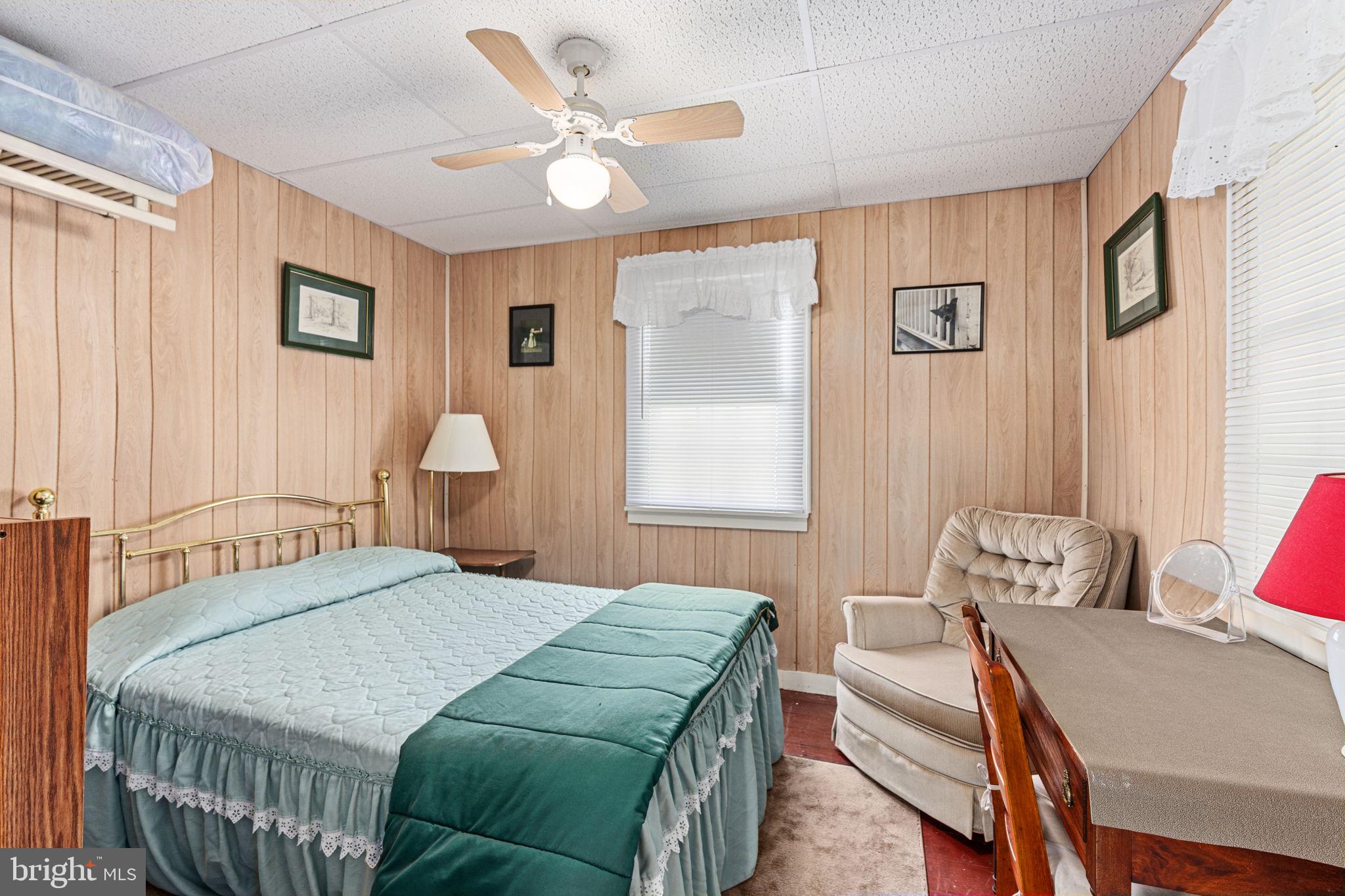 1285 Nursery Road, Unit CABIN 5 Green Lane, PA 18054 - Photo 16 of 34 a bedroom with a bed and a chandelier