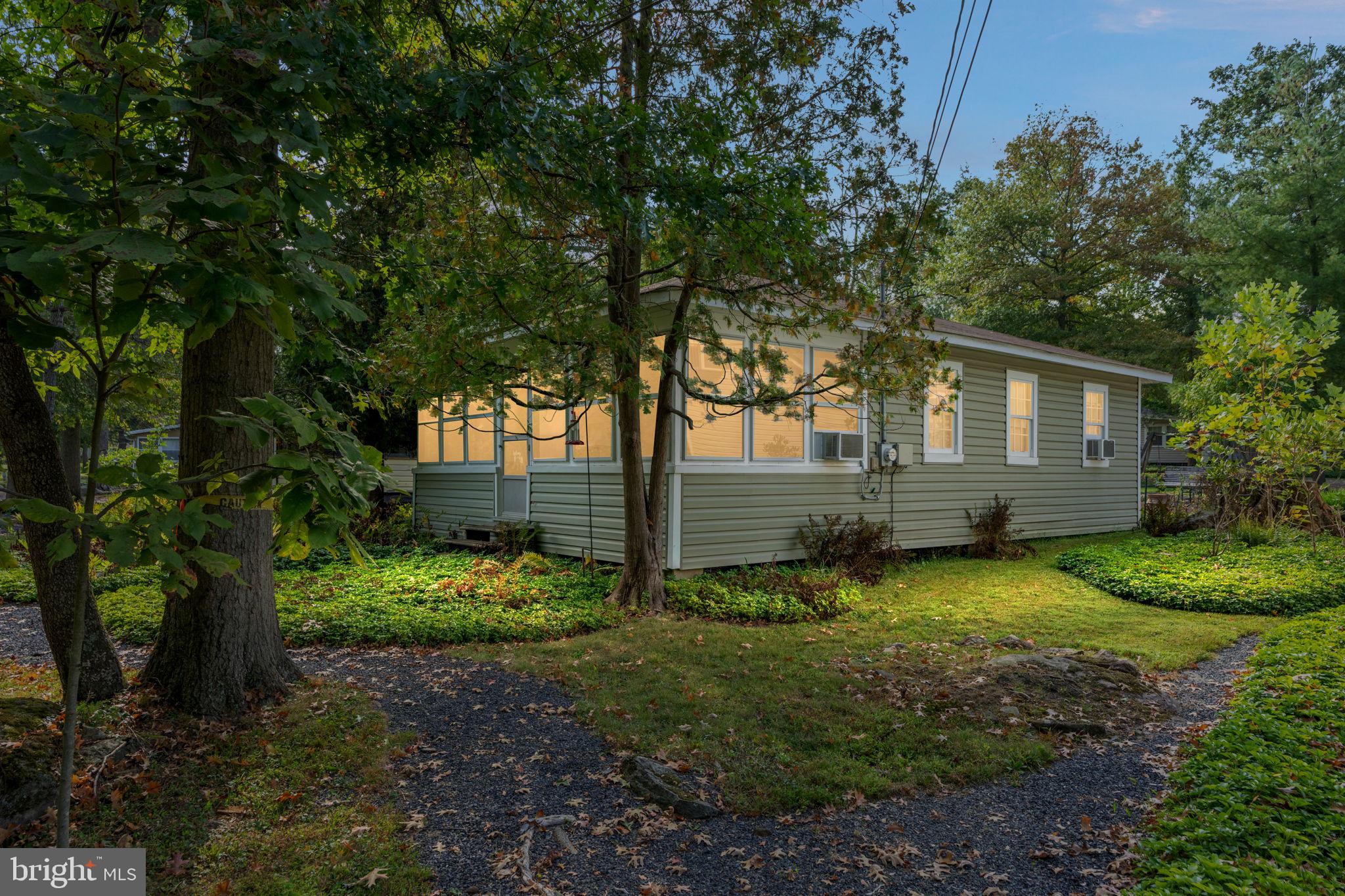 1285 Nursery Road, Unit CABIN 5 Green Lane, PA 18054 - Photo 2 of 34 a view of a backyard with plants and large trees