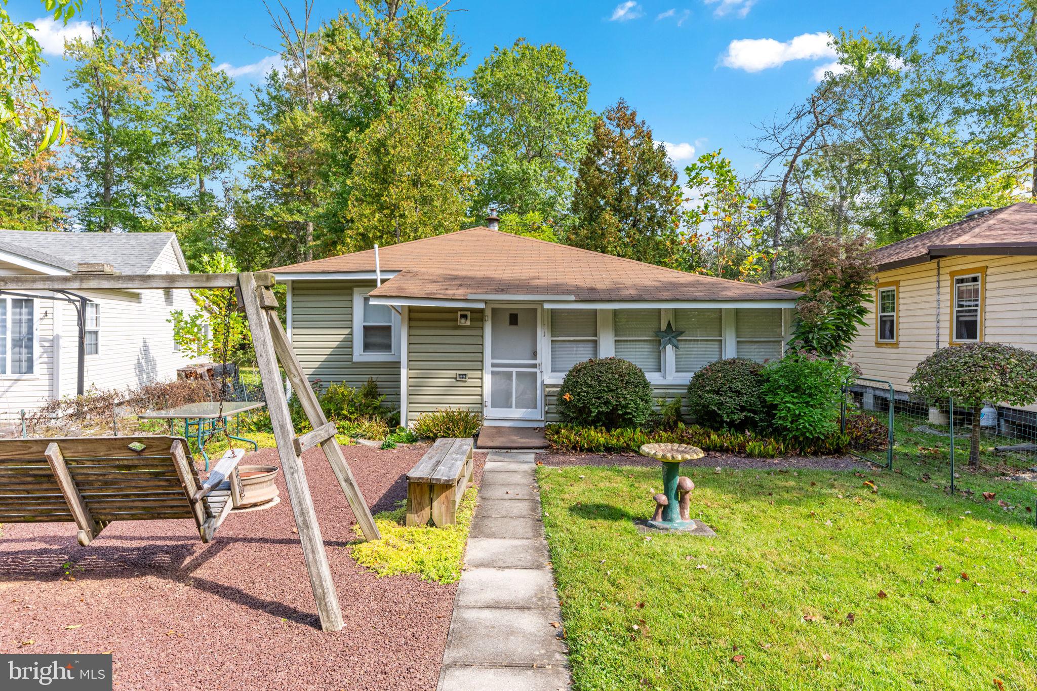 1285 Nursery Road, Unit CABIN 5 Green Lane, PA 18054 - Photo 25 of 34 a view of a house with backyard sitting area and garden