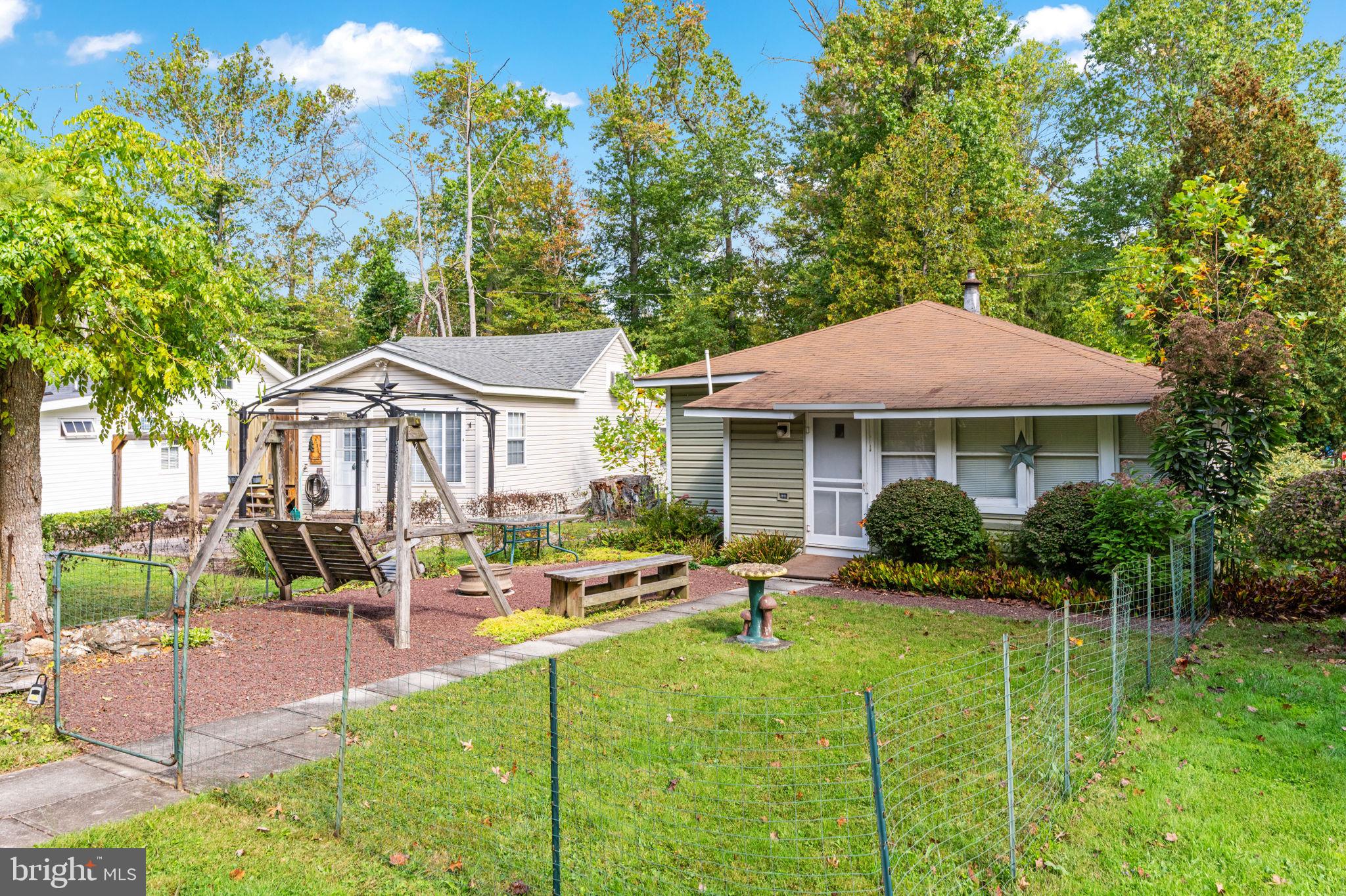 1285 Nursery Road, Unit CABIN 5 Green Lane, PA 18054 - Photo 26 of 34 a patio with sofas fire pit table and chairs