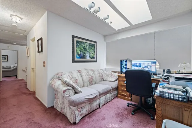 a living room with furniture and a piano