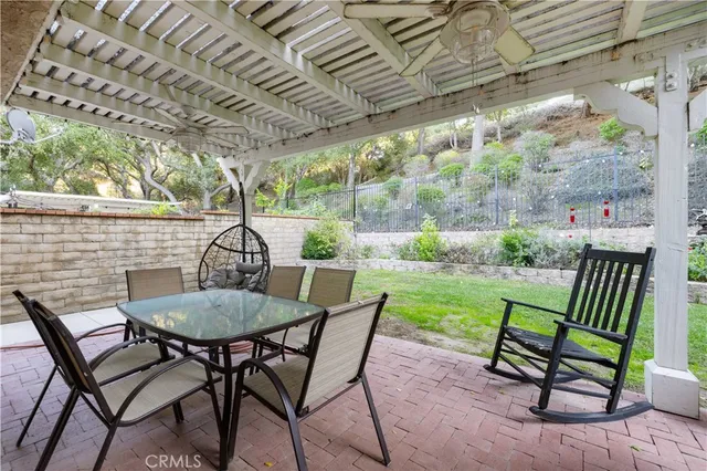 a view of a patio with table and chairs potted plants with wooden floor