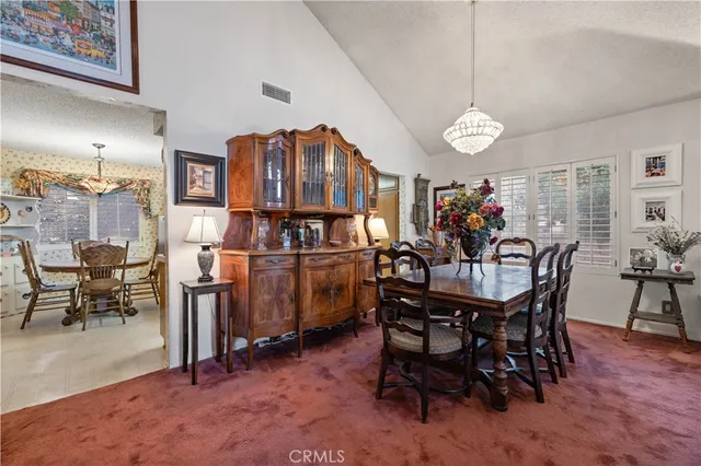 a view of a dining room with furniture and chandelier