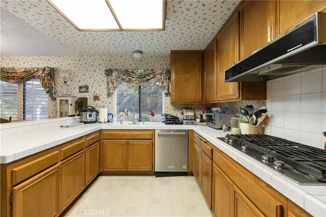 a kitchen with a sink stove and cabinets