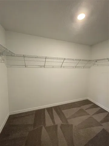 an empty room with a empty space and windows