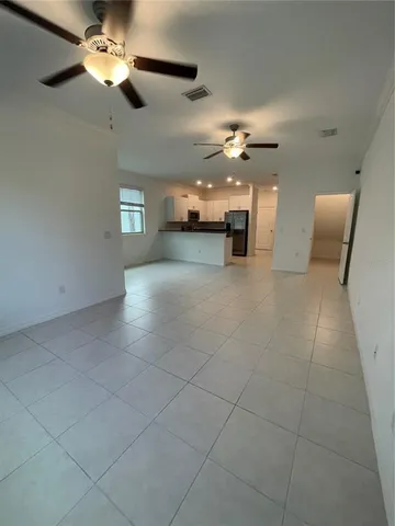 a view of a livingroom with furniture and chandelier fan