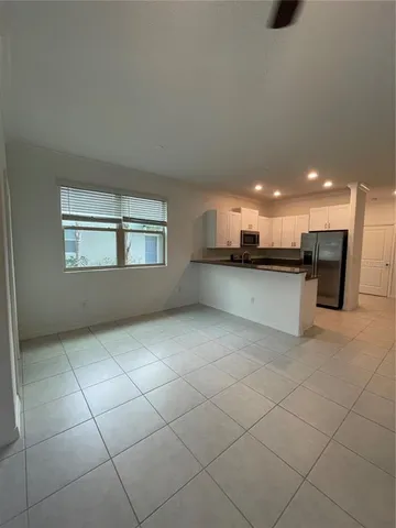 a kitchen with stainless steel appliances kitchen island granite countertop a sink and cabinets