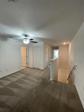 an empty room with a empty space and a ceiling fan