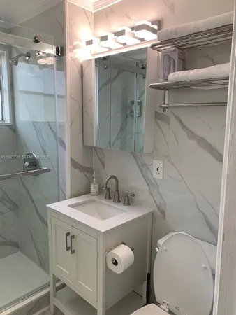 a bathroom with a sink toilet and shower