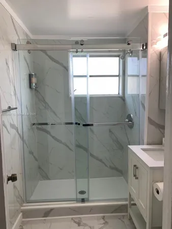 a bathroom with a shower and a tub
