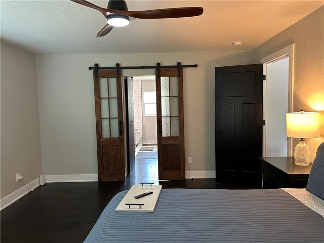 a bathroom with a granite countertop toilet and a sink