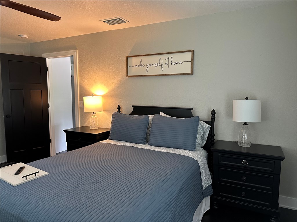 4135 Grant Road Grant Valkaria, FL 32949 - Photo 14 of 26 a bedroom with a bed and wooden floor